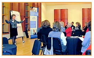 Susan Marshall speaking at a lectern